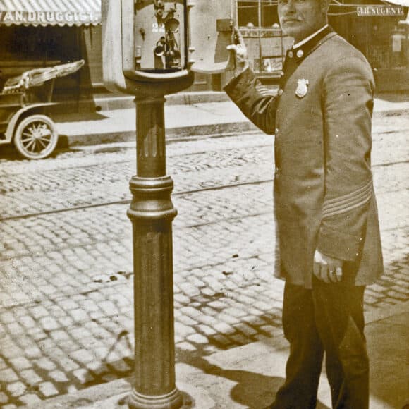 Police Chief _____ ____ demonstrating new Police call box on Wall St., c. _____ | NM-FIC-0941 | Norwalk Library History Room
